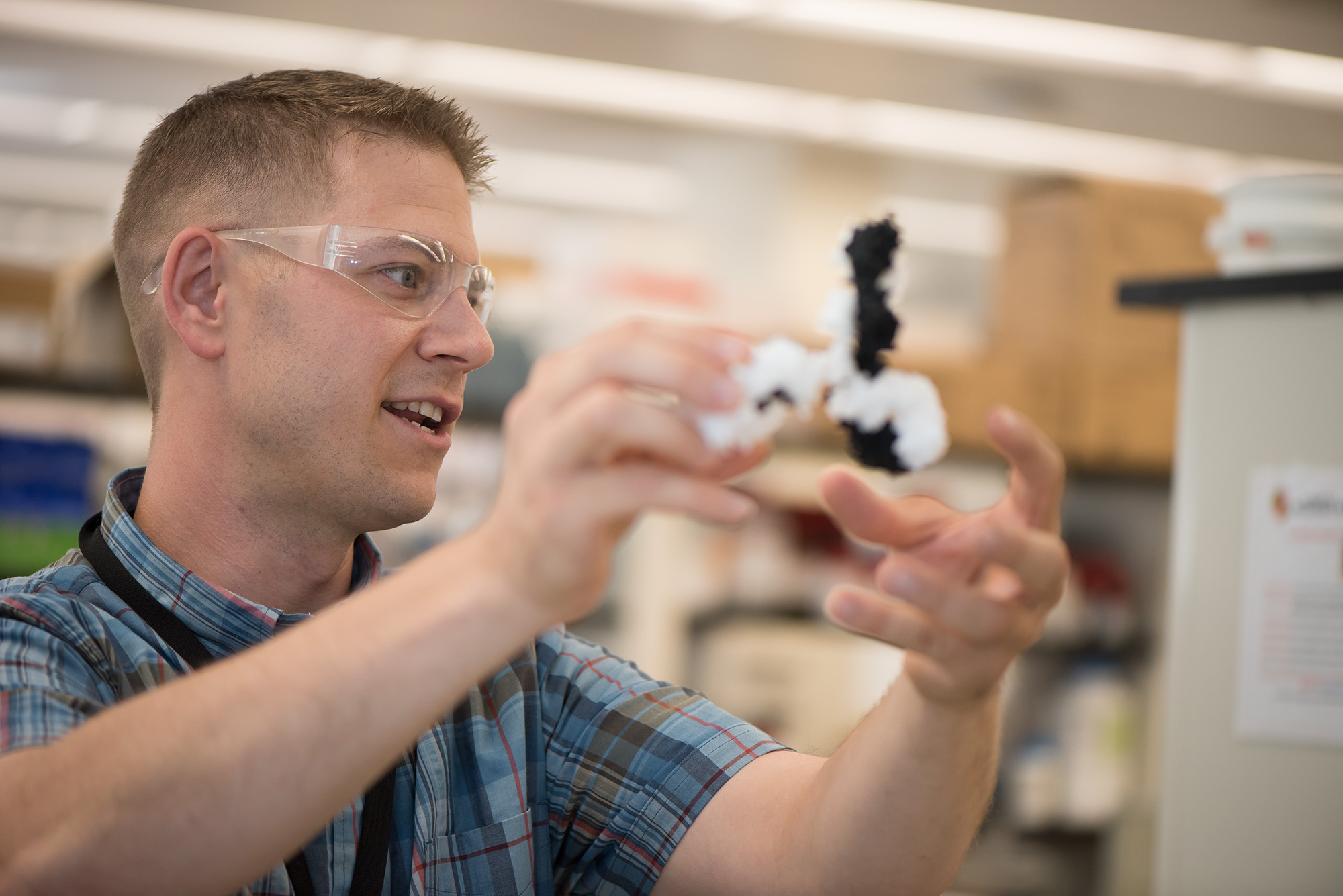 Dr. John Schiel holding a figure of the NISTmAb